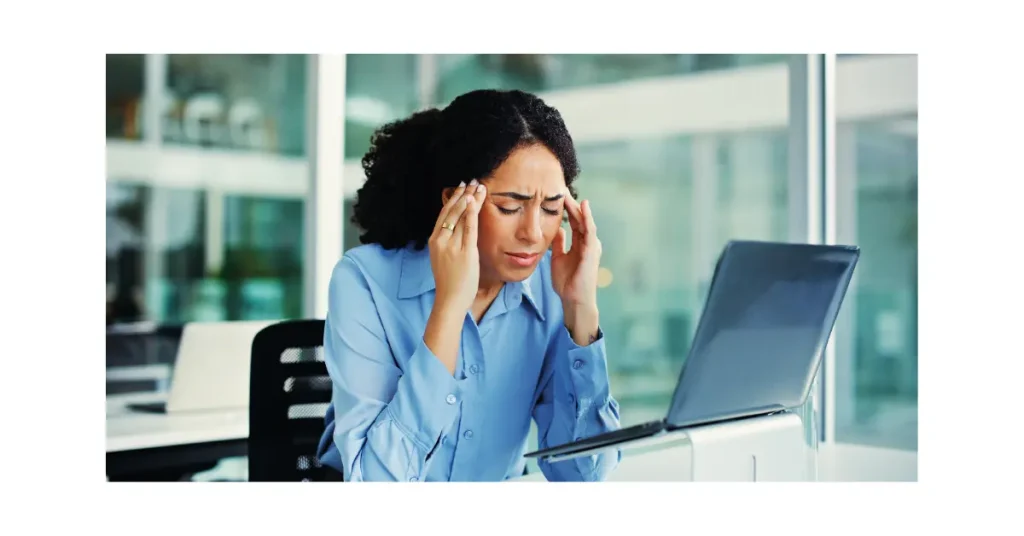 Woman looking stressed while using a laptop, highlighting frustration with online council digital services