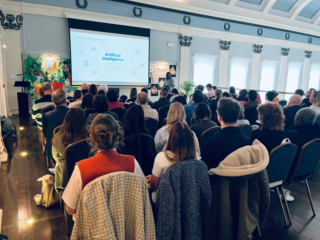 Beverly Clarke MBE presenting an Artificial Intelligence workshop to a packed hall of attendees.