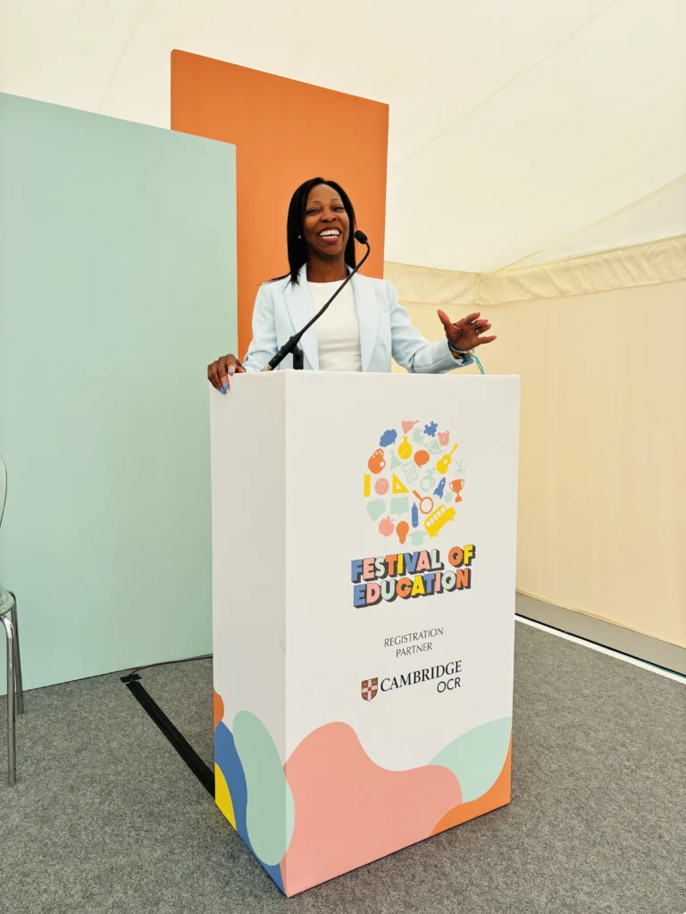 Beverly Clarke MBE speaking from a lectern at the Festival of Education.